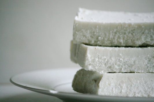 Stack of Lavender Mint Splash Sea Salt Bars on a white plate, showcasing a spa-quality experience for daily showers.