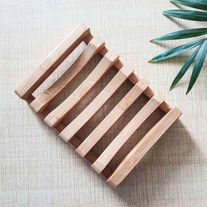 Natural bamboo soap dish on a textured background, promoting eco-friendly, biodegradable living.