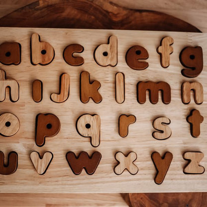 Natural lower case letter puzzle with wooden letters, ideal educational toy for early childhood learning.