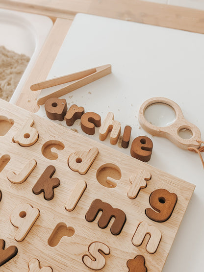 Natural lower case letter puzzle with wooden letters spelling 'archie', promoting early learning and motor skills.