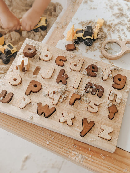 Natural lower case letter puzzle on a wooden board, perfect for early learning and fine motor skills development.