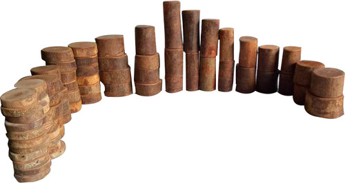Wooden toy cylinders lined up in a curved formation, showcasing their natural texture and craftsmanship.