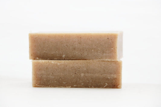 Two natural Peppermint Cream Soap bars stacked, showcasing creamy texture and earthy tones.