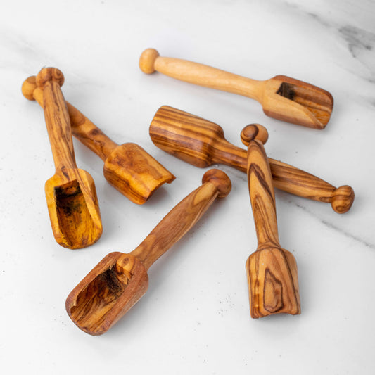Handcrafted mini wooden scoops made from olive wood, perfect for measuring spices, coffee, and sugar.