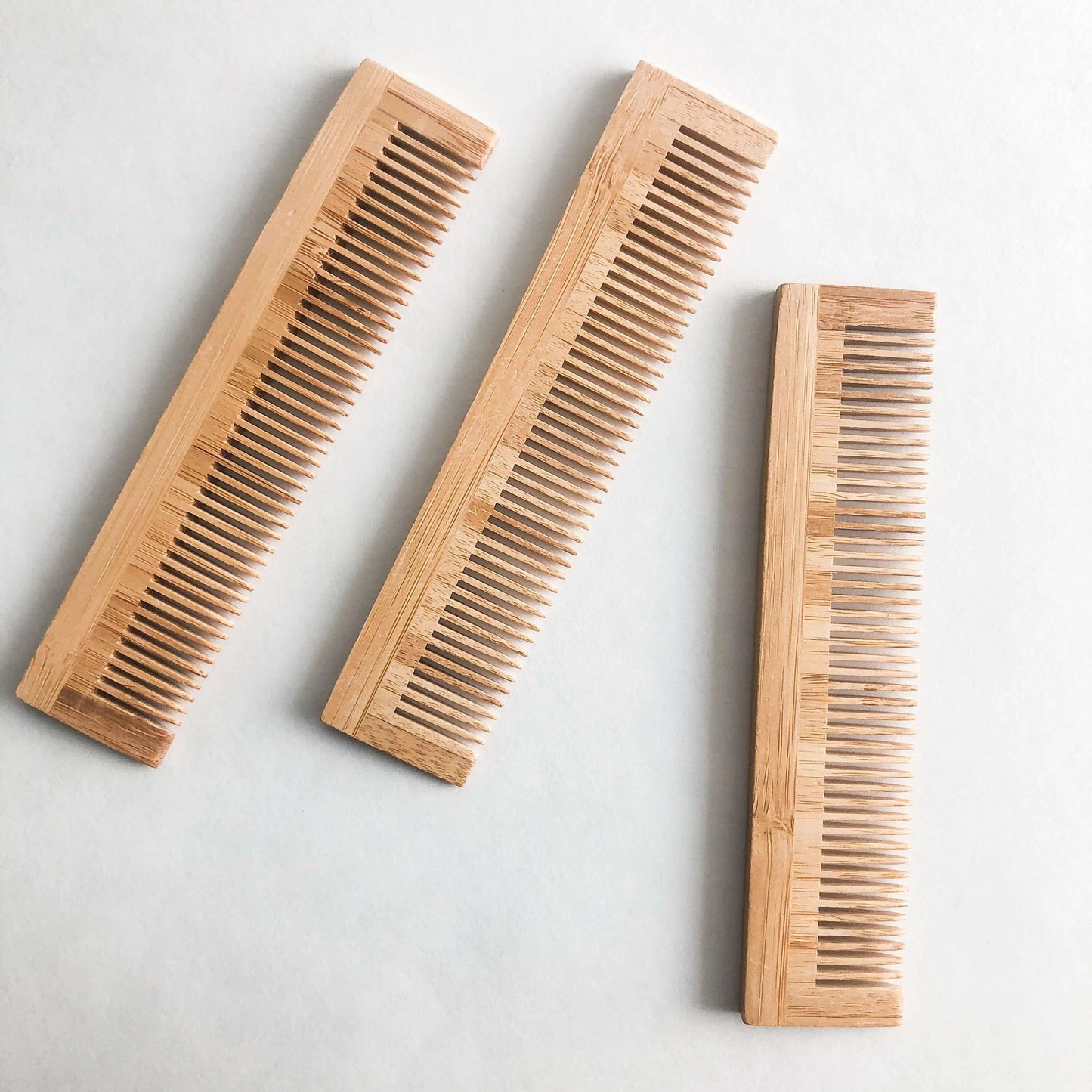 Set of three eco-friendly bamboo combs, perfect for gentle hair care and zero waste lifestyle.