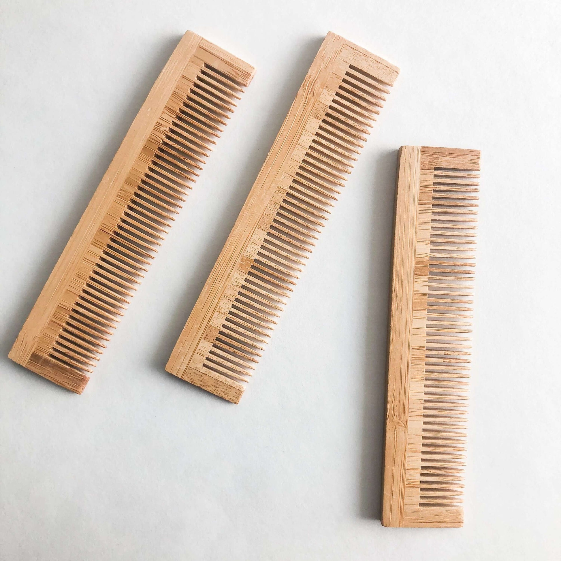 Set of three eco-friendly bamboo combs, perfect for gentle hair care and zero waste lifestyle.