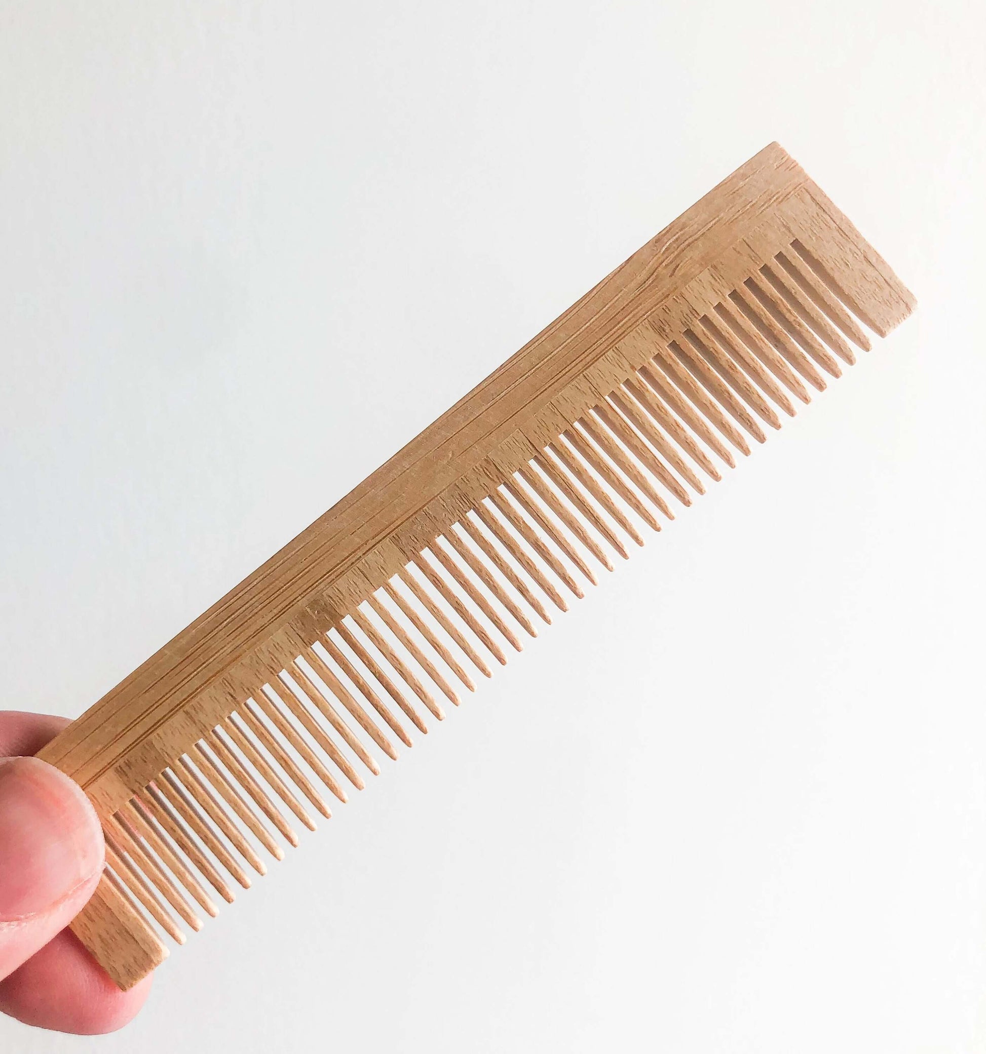 Natural bamboo comb for all hair types, eco-friendly, plastic-free, static-free, smooth gliding teeth.