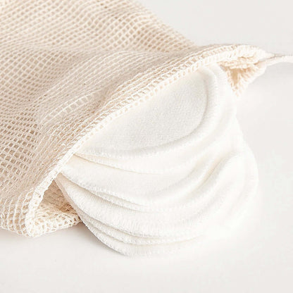 Organic bamboo cotton facial pads in a mesh bag, perfect for zero-waste skincare and eco-friendly makeup removal.