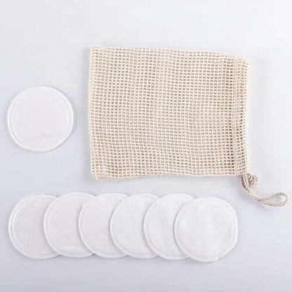 Reusable organic bamboo cotton facial pads and mesh bag for eco-friendly skincare.