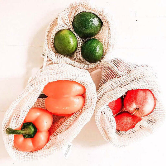Reusable organic cotton mesh produce bags with fresh fruits and vegetables, eco-friendly, zero waste solution.