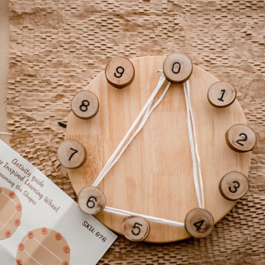 Steiner Inspired Learning Wheel with numbered wooden pieces and activity guide for cognitive development.
