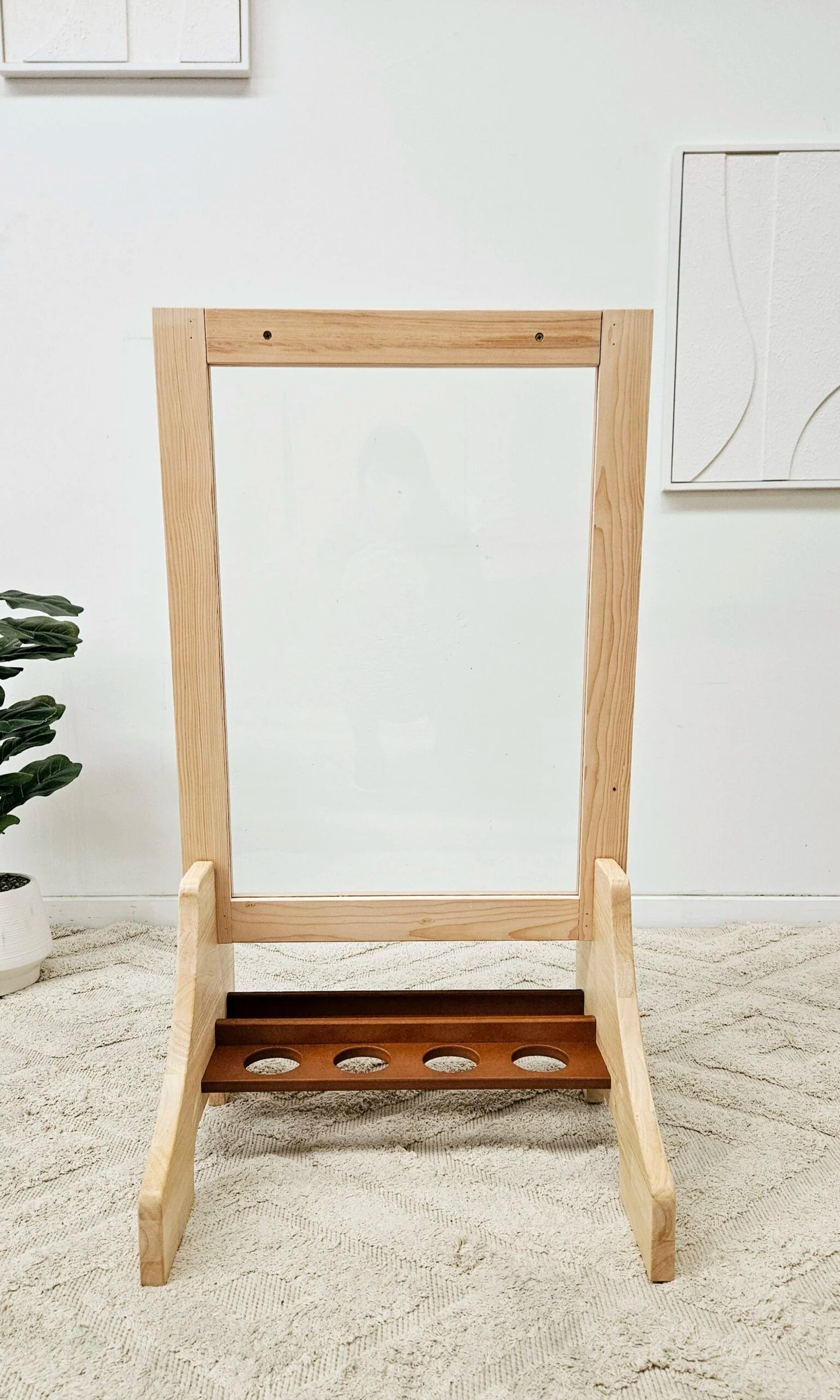 Double-sided wooden easel for toddlers with perspex panels and a paint tray, perfect for creative art sessions.
