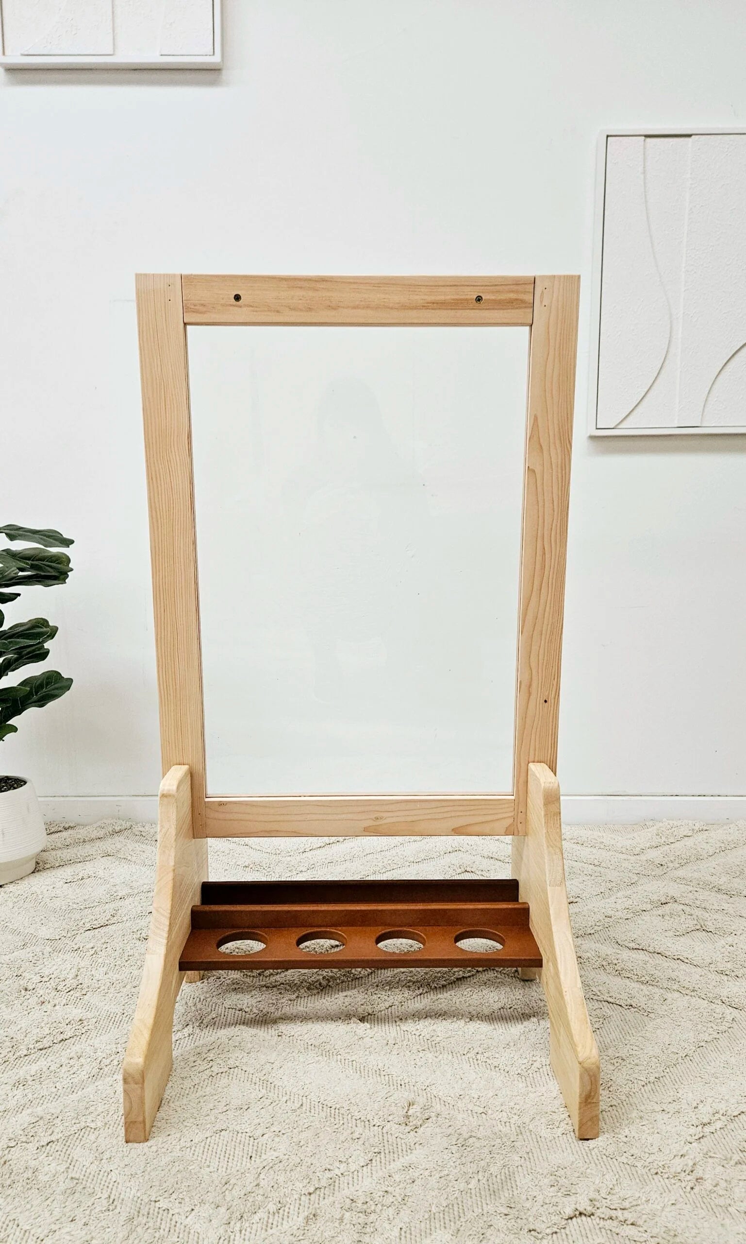 Double-sided wooden easel for toddlers with perspex panels and a paint tray, perfect for creative art sessions.