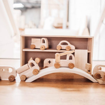Wooden vehicle play set with cars, bridge, and garage storage, promoting imaginative play and road safety skills.