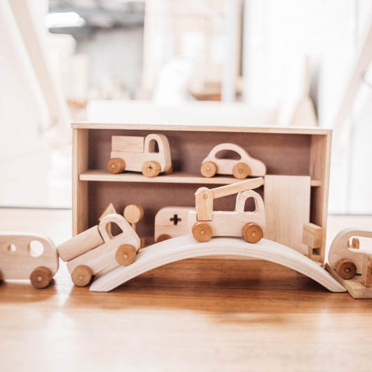 Wooden vehicle play set with cars, bridge, and garage storage, promoting imaginative play and road safety skills.