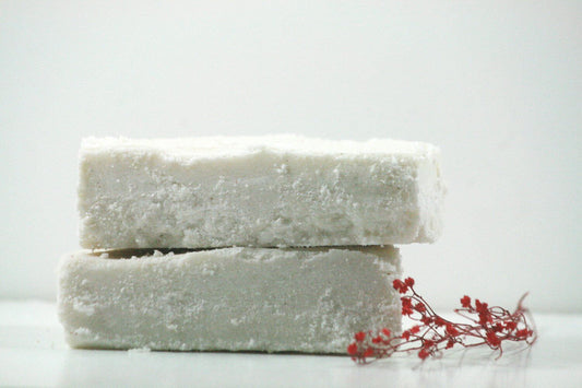Handcrafted Winter Calm Sea Salt Bar soap with a creamy texture and pink flower accents, ideal for skin rejuvenation.
