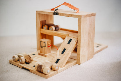 Wooden toy workshop with ramps, wheels, and tools, designed for creative play and motor skill development.