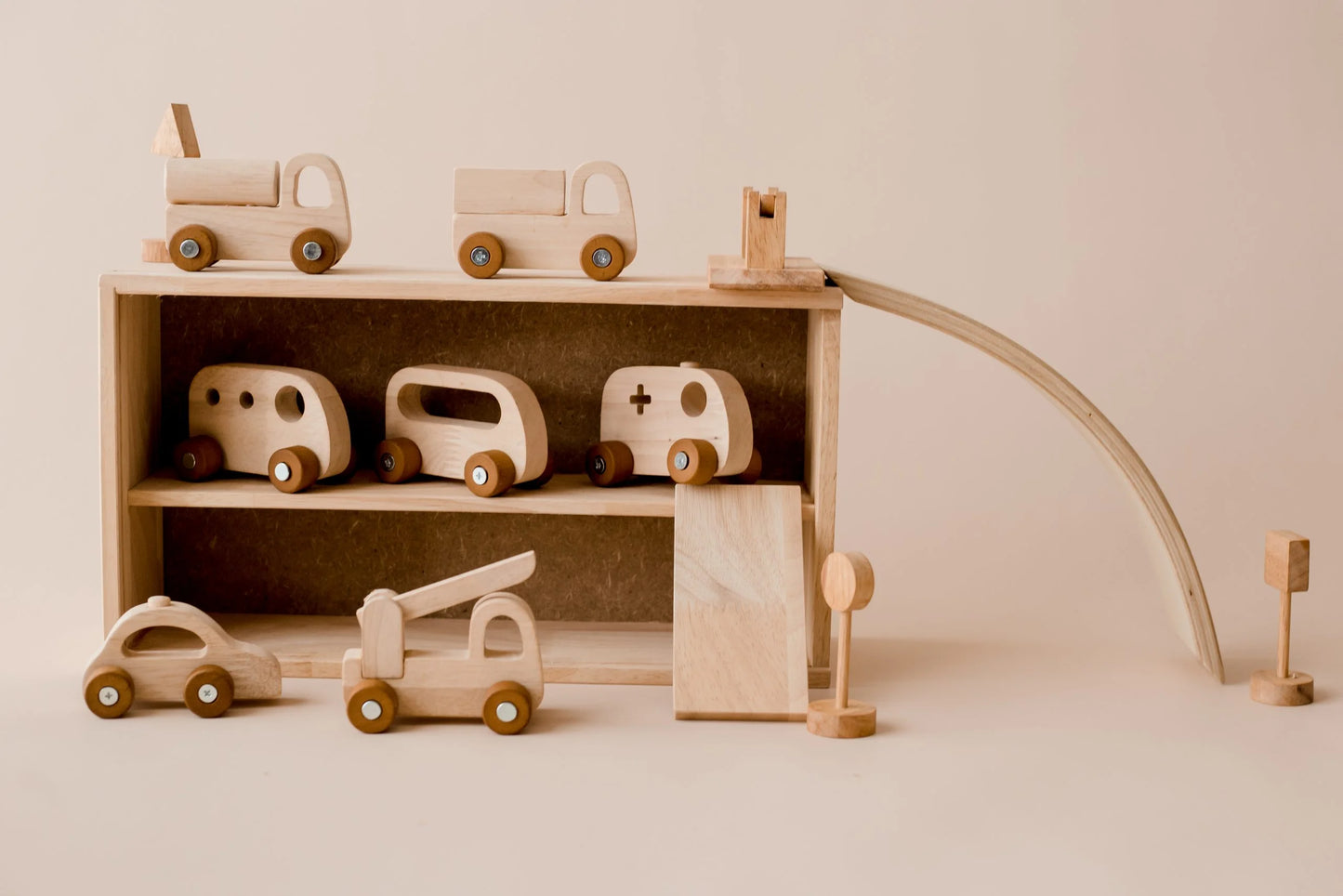 Wooden vehicle play set featuring cars, traffic signs, and storage garage for imaginative play and road safety learning.