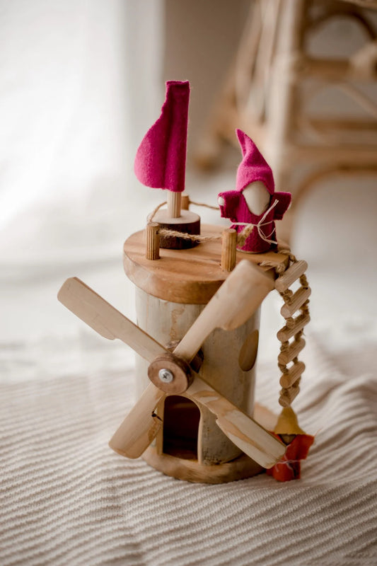 Wooden windmill toy with spinning blades and colorful flags, perfect for imaginative play and STEM learning for toddlers.